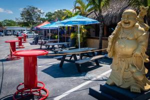 a statue of a man sitting next to a table at New! Remodeled, Pool-Side, 1-min to Beach Path! in Siesta Key
