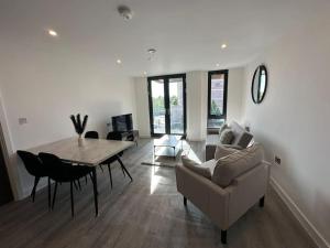a living room with a table and a chair at Luxury central York Apartment in York