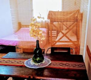 a vase with flowers in it sitting on a table at Altos del Peñón Cabañas in Casa Grande +40 photos