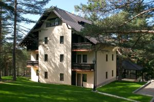 a large white building with a black roof at Vila Pina in Zlatibor