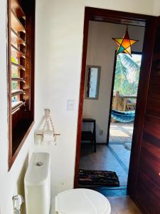 a bathroom with a toilet and a star on the wall at Pousada kaz'oca in Icaraí