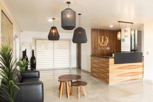 a living room with a table and two stools at Hotel Quinta Los Laureles in Atlixco