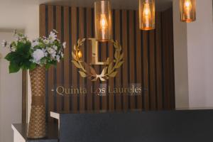 a chandelier hanging over a table with a vase of flowers at Hotel Quinta Los Laureles in Atlixco