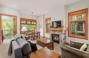 a living room with a couch and a fireplace at Foxtail Flat Capitol Peak's Coziest Corner Unit in Snowmass Village