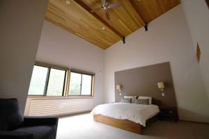 a bedroom with a bed and a large window at Chalet Tacito Niseko Luxury Stay in Niseko +27 photos
