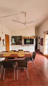 a dining room with tables and chairs in a room at Casa Los Bolitos in Los Hornillos