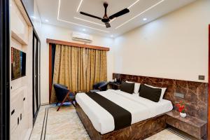 a hotel room with a bed and a window at Hotel O DEVOM INN in Greater Noida +33 photos
