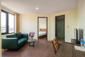 a living room with a couch and a table at Granda Hanoi Hotel & Apartment in Hanoi +1 photo