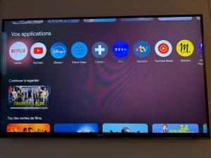 a television screen with a bunch of different websites at DAMA Lodge in La Ferté-Bernard