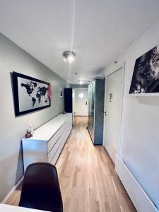 a room with a bed and a chair and a hallway at Koselig leilighet i smeaheia in Sandnes