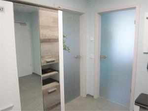 a closet with a glass door in a room at Ferienwohnung im Kirschfeld - 5* in Kues +14 photos