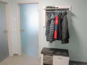a room with a closet with jackets hanging on a wall at Ferienwohnung im Kirschfeld - 5* in Kues
