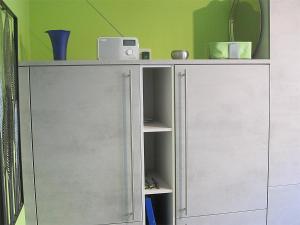 a white cabinet with a speaker on top of it at Ferienwohnung im Kirschfeld - 5* in Kues