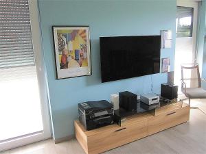 a living room with a flat screen tv on a wall at Ferienwohnung im Kirschfeld - 5* in Kues