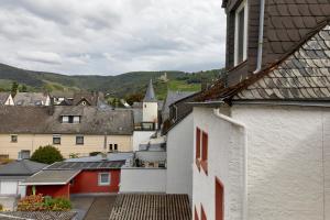 a group of buildings in a town with mountains at Haus am Hafen in Bernkastel-Kues