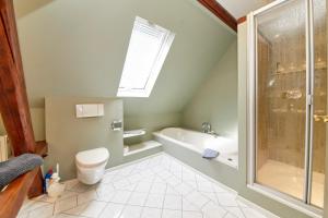 a bathroom with a tub and a toilet and a shower at Haus am Hafen in Bernkastel-Kues +32 photos