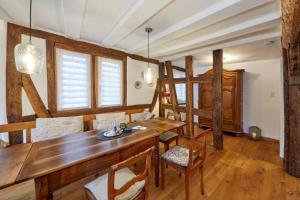 a dining room with a wooden table and a bunk bed at Ferienwohnung Badstube Anno 1583 in Bernkastel-Kues