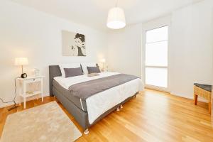 a bedroom with a large bed and a large window at Ferienwohnung "Auszeit" in Bernkastel-Kues
