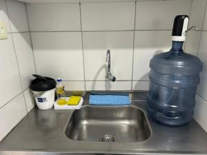 a kitchen sink with a bottle of water next to it at Recife - Boa Vista in Recife +55 photos