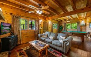 a living room with a couch and a pool table at Beary Inn and Sweets in Pigeon Forge