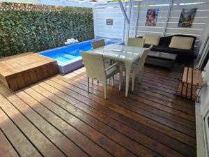 a patio with a table and chairs and a swimming pool at SARL FARE MOOREA in Moorea