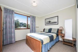 a bedroom with a bed and a window at Blue View - UNINTERRUPTED OCEAN VIEWS FOR MILES in Guilderton