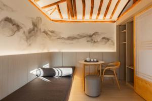 a room with a table and a chair at Luxury Hanok Moonlight Hill in Seoul