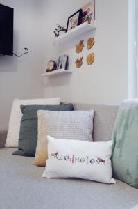 a living room with a couch with a pillow at Travelers Dream, Walk to Space Needle, Firepit, cornhole in Seattle