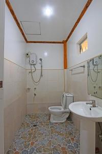 a bathroom with a toilet and a sink at Villa Consolacion Resort in General Luna +89 photos