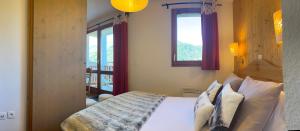 a bedroom with a bed and a window at Cosy Montagne in Valmeinier +27 photos