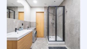 a bathroom with a sink and a shower at Sv1 Amber Oldtown SELF CHECK-IN by QuarterStays in Vilnius