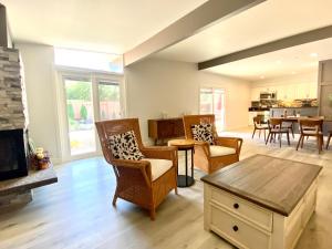 a living room with chairs and a fireplace at NEW cozy beautiful house with pool and hot tub in Fair Oaks
