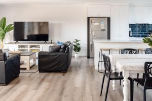 a living room with a kitchen and a dining room at Sandy Shores in Inverloch