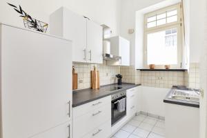 a white kitchen with a sink and a window at Ferienwohnungen am Gestade Wohnung 2 in Bernkastel-Kues