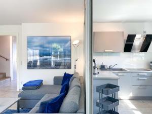 a living room with a couch and a kitchen at Ferienhäuser Doppelhaushälfte Hahn in Wustrow +12 photos