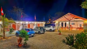 un grupo de coches aparcados delante de un edificio en Edelmon't Beach, en Los Órganos