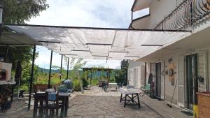 a patio with tables and chairs under a canopy at suite in cascina affittacamere in Casalborgone