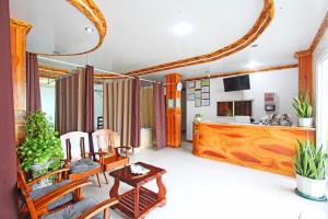 a living room with a table and chairs and a kitchen at Villa Consolacion Resort in General Luna