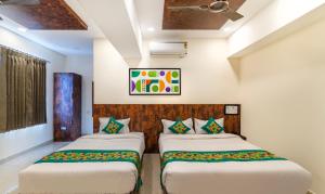 A bed or beds in a room at Treebo Rakshitha, Porur