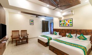 A bed or beds in a room at Treebo Rakshitha, Porur