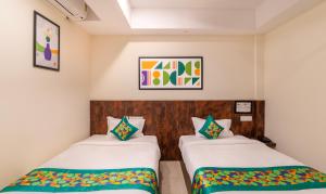 A bed or beds in a room at Treebo Rakshitha, Porur
