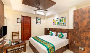 A bed or beds in a room at Treebo Rakshitha, Porur