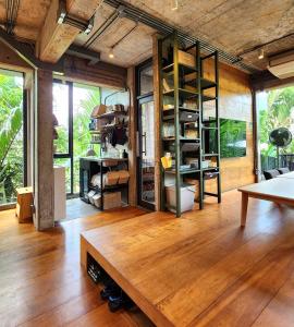 a living room with wooden floors and a table at hiddenwoods in Bang Chak
