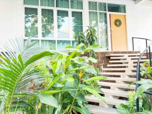 a house with a bunch of plants in front of it at 5BRHouse City centre Silom 3min to BTS Saint Louis in Bangkok