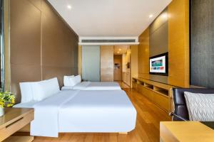 Postel nebo postele na pokoji v ubytování Guangzhou City Inn Hotel Apartment Pazhou