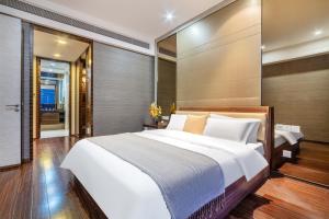 Postel nebo postele na pokoji v ubytování Guangzhou City Inn Hotel Apartment Pazhou