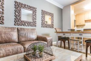 a living room with a couch and a table at Avemore Vredehof No 2 - full Backup Power in Stellenbosch
