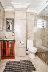 a bathroom with a toilet and a shower and a sink at Avemore Eikehoff No 26 in Stellenbosch
