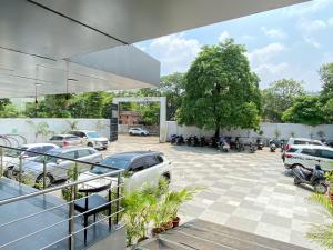 a parking lot with cars parked in a parking lot at SwagStay Hotel OwnHouse 181 Nagpur in Nagpur
