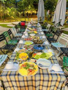 a long table with plates of food on it at Fla Village in Phú Quốc